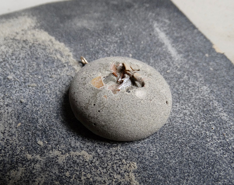 sanding an Icy Mouse concrete jewel